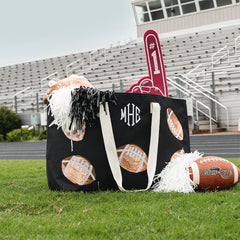 Football XL tote on field in front of bleachers