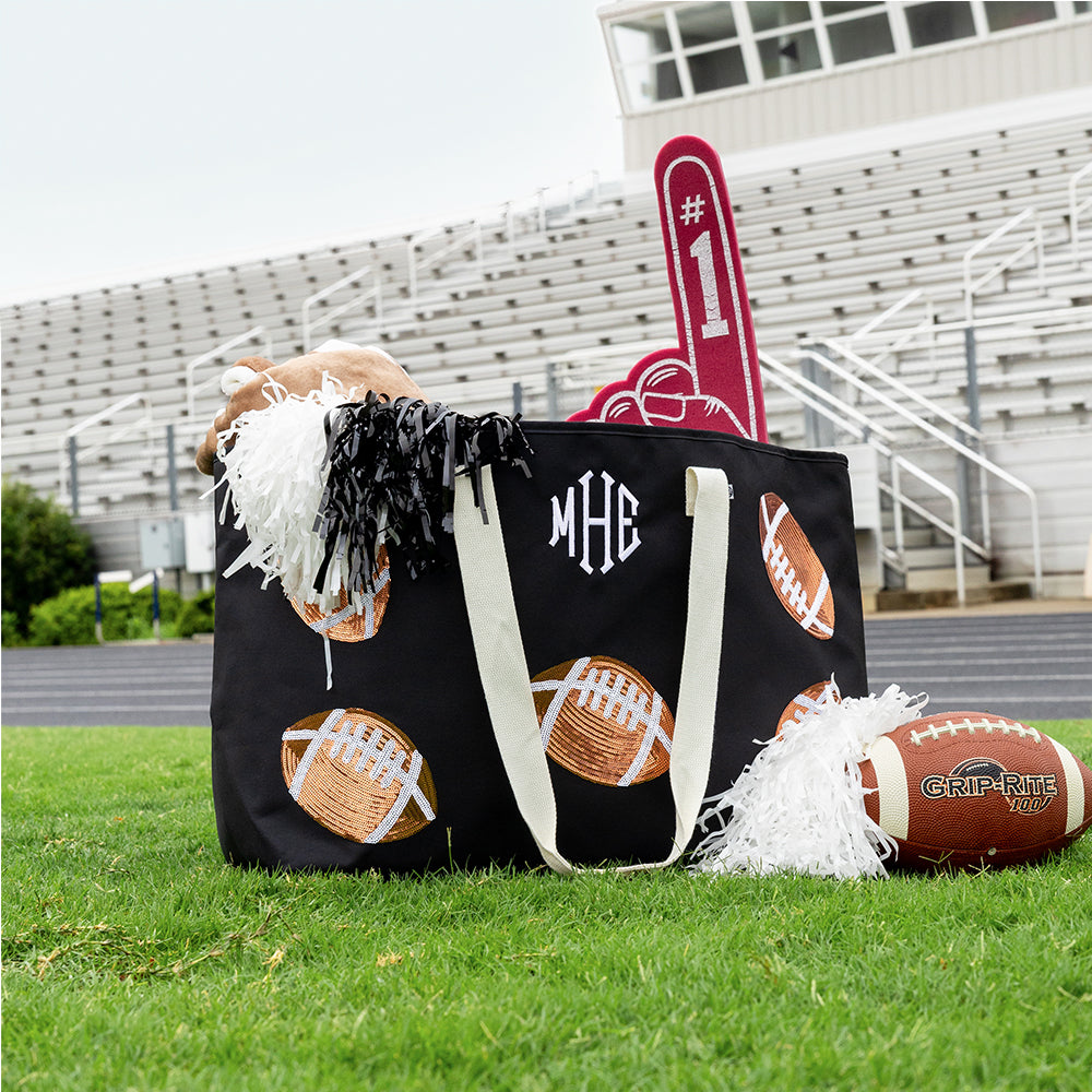 Football XL tote on field in front of bleachers