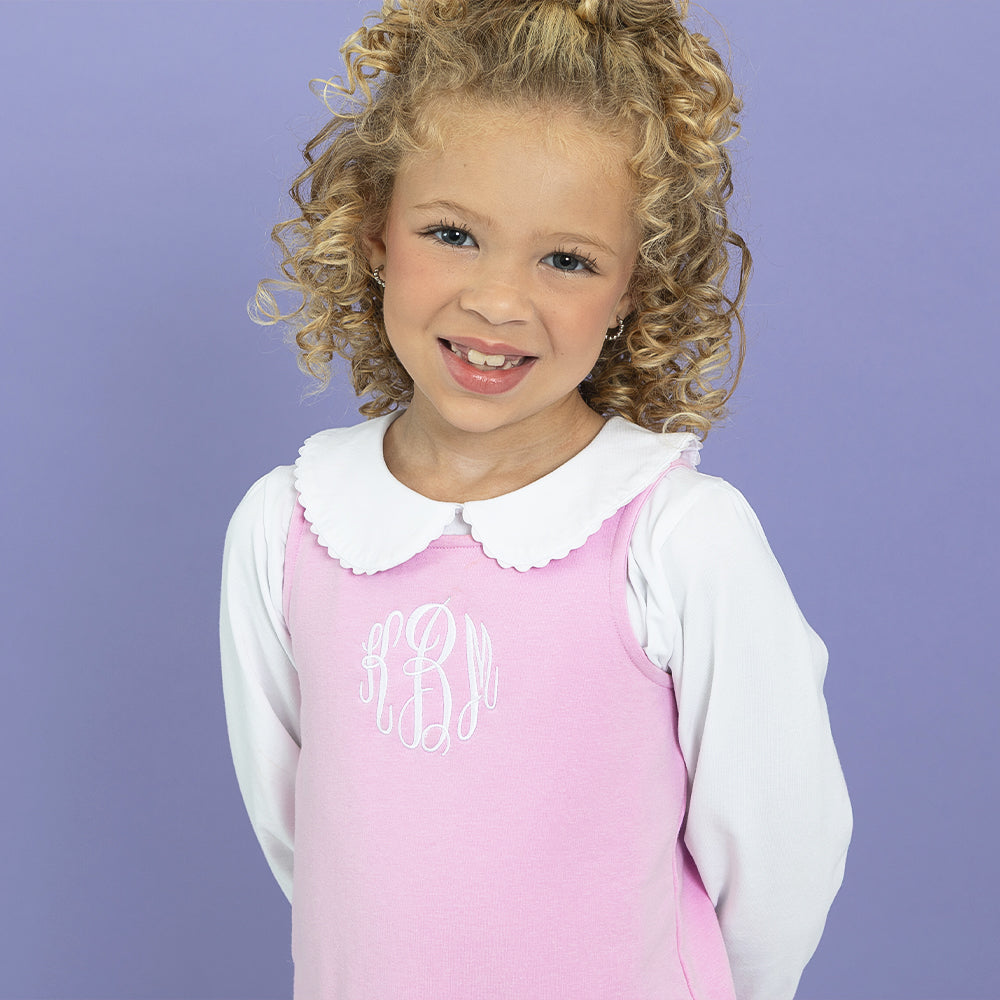 Girl wearing jumper dress with collared shirt close up