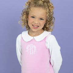 Girl wearing jumper dress with collared shirt close up