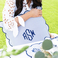 navy seersucker scalloped pillow sham in hands