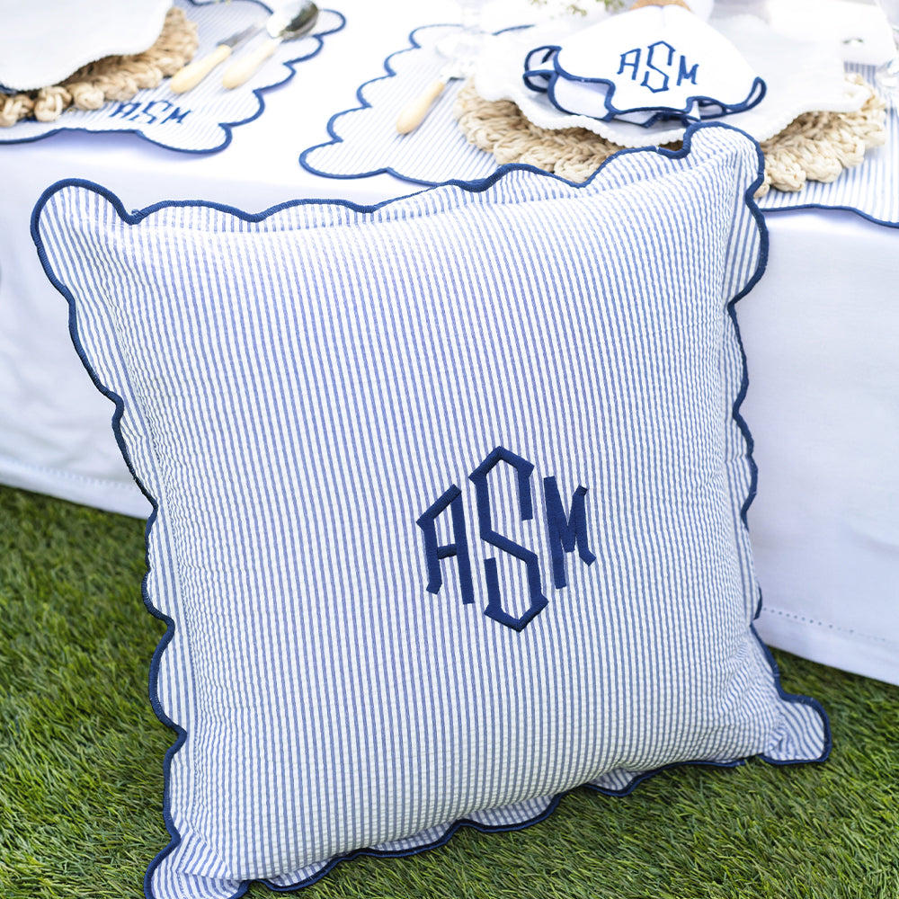 navy seersucker scalloped pillow sham on grass