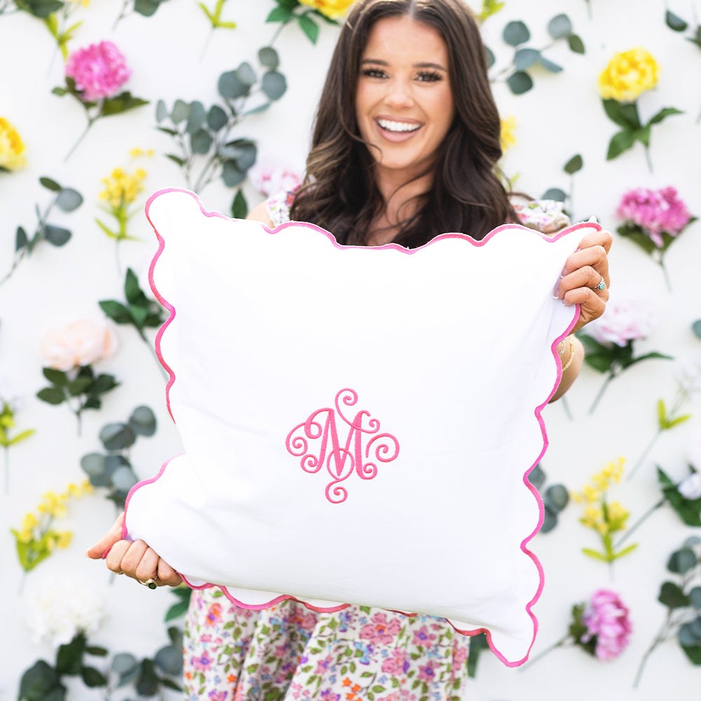 pink scalloped pillow sham in hands