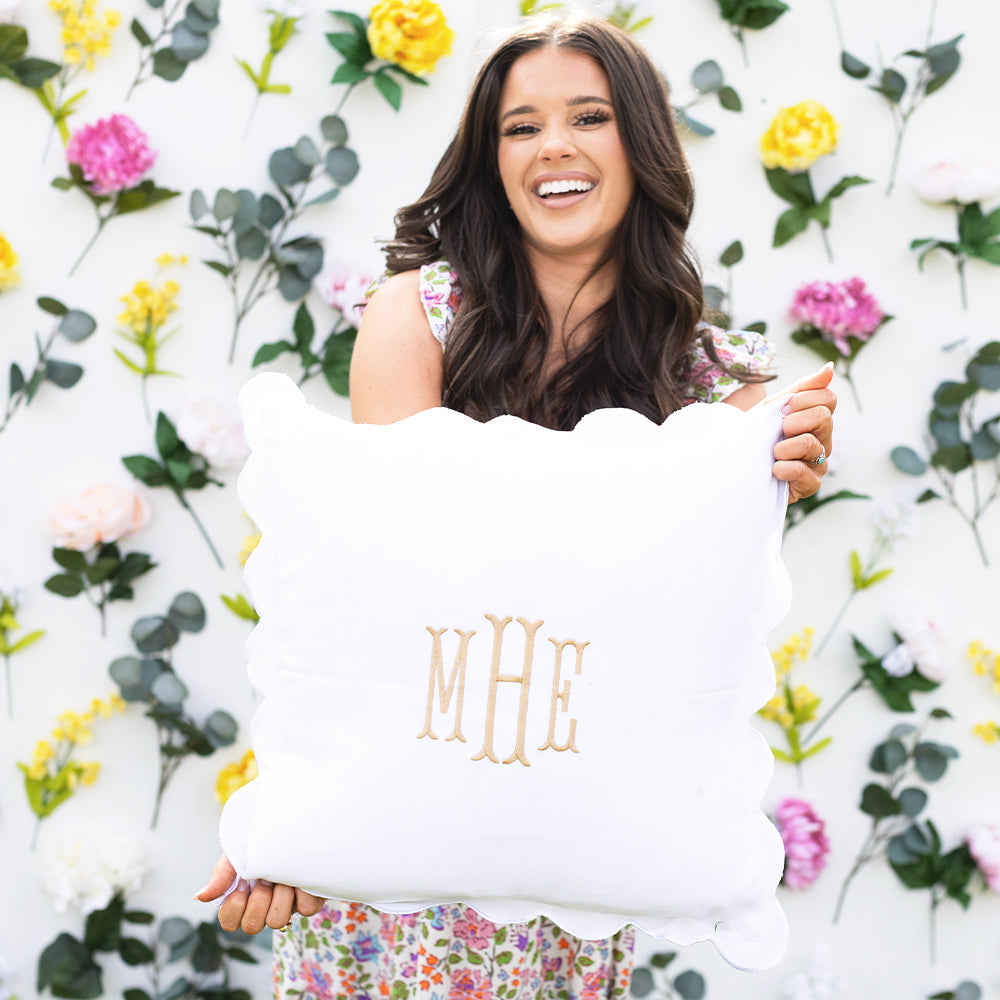 white scalloped pillow sham in hands