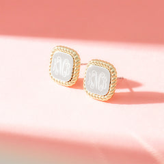 cable stud earrings on pink background