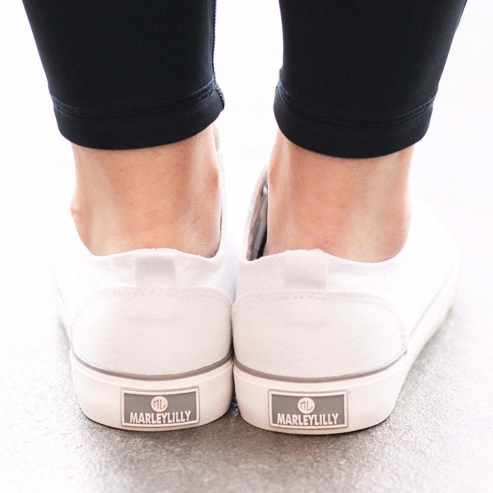 marleylilly branding on the back of monogrammed white canvas sneakers