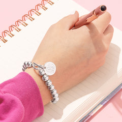 silver monogrammed kids ball bracelet on wrist