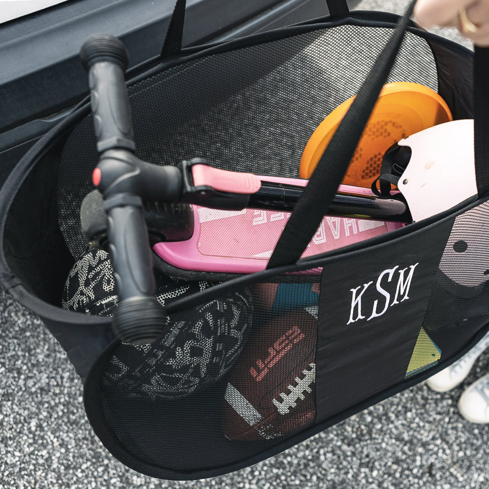 inside of black personalized pop up bag with kids outdoor toys