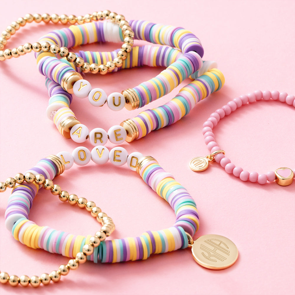 girls you are loved bracelets on pink background