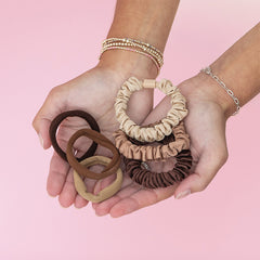 Neutral hair tie set in hands