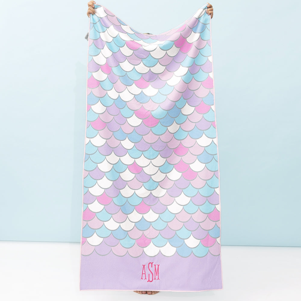 girl holding monogrammed kids beach towel in mint mermaid