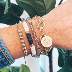 gold monogrammed link lock disc bracelet stack