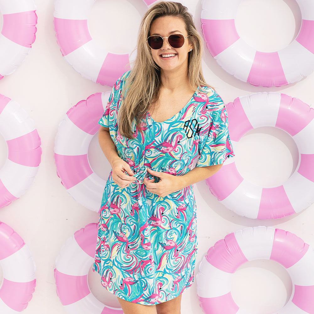 girl wearing monogrammed cinch waist cover up in blue and pink flamingo splish splash