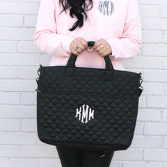 black quilted laptop bag in hands
