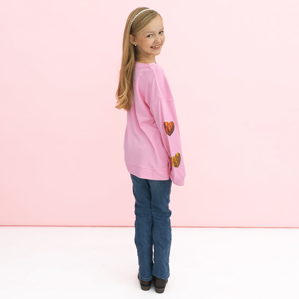 back of girl wearing kids sequin hearts sweatshirt