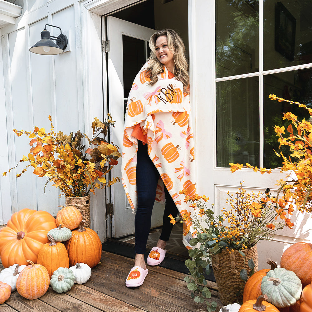 Posh Pumpkins blanket around girl on fall porch