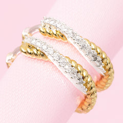 close up of silver and gold pave cable hoop earrings