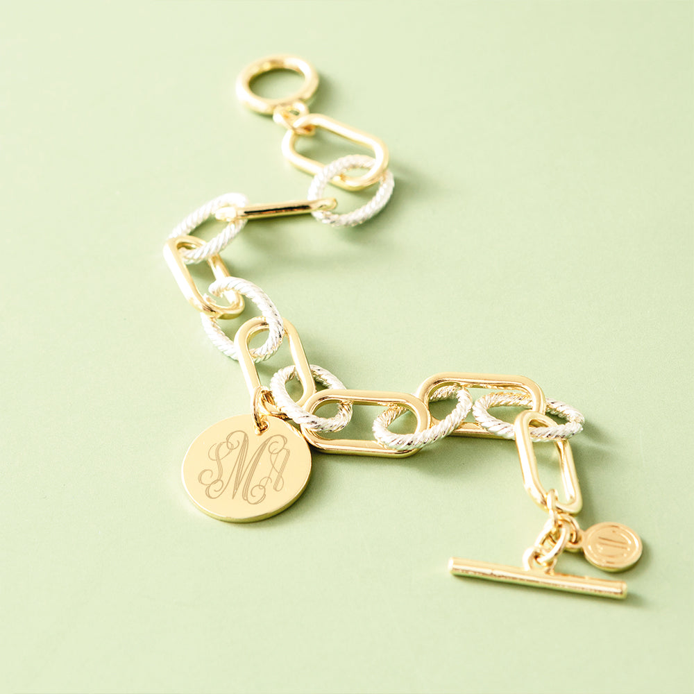 mixed metal chainlink bracelet on green background