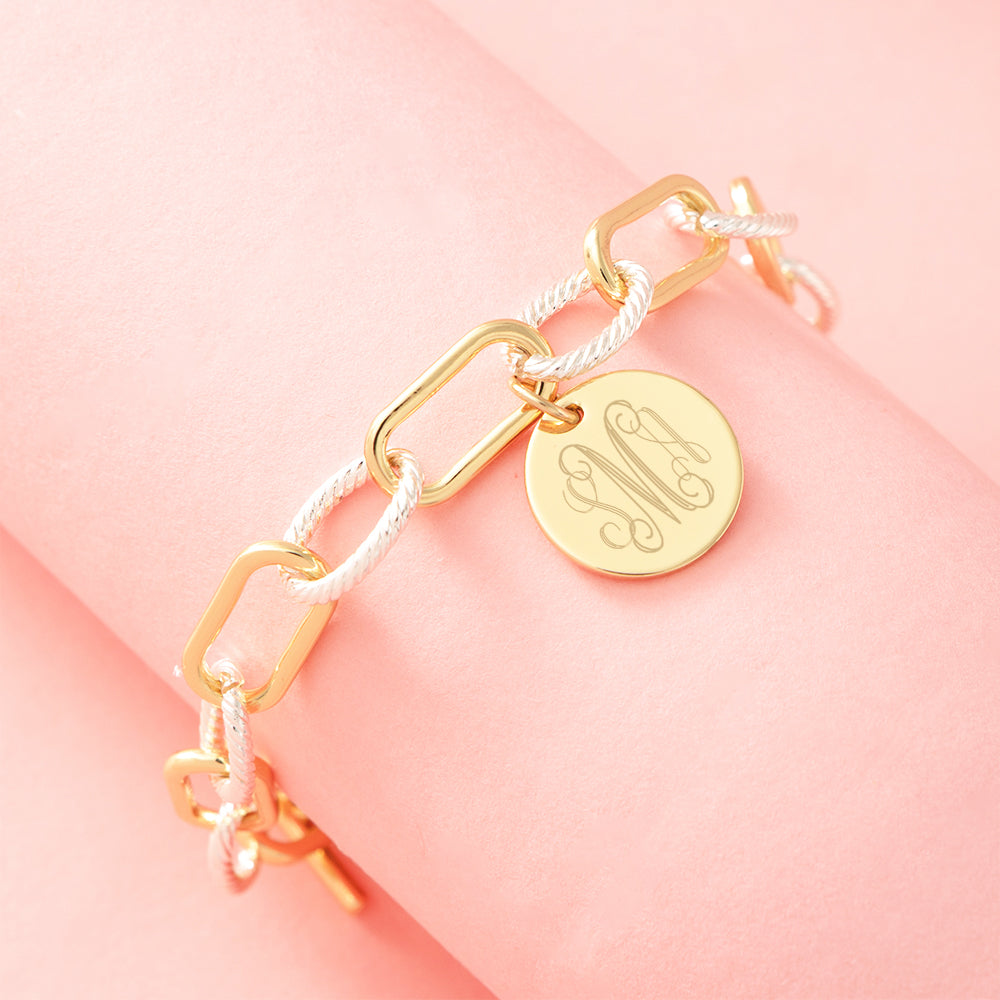 mixed metal chainlink bracelet on pink background