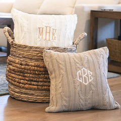 two cable knit pillow shams with basket