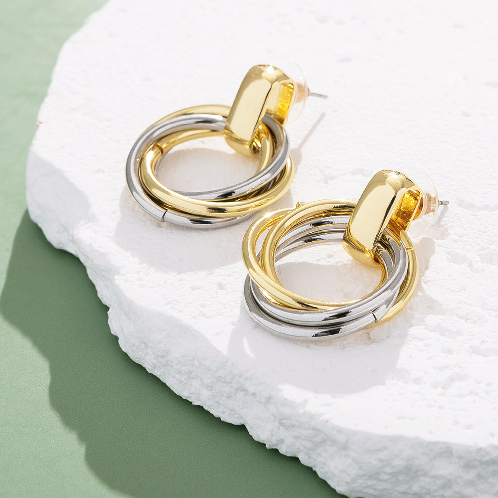 Round Mixed Metal Earrings on rock on green