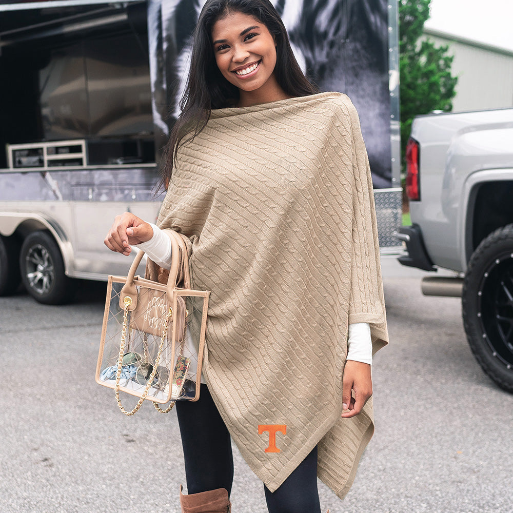 girl wearing tennessee vols poncho at tailgate
