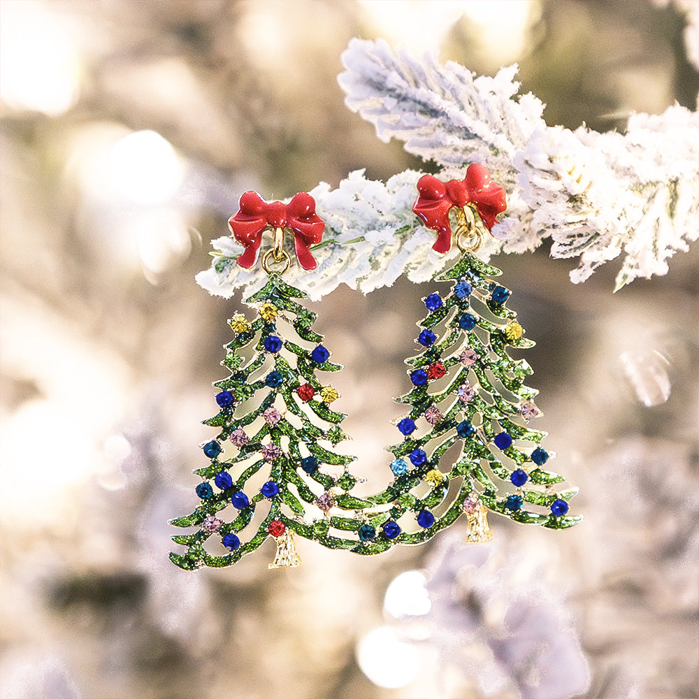 beaded christmas earrings in green hanging on winter tree