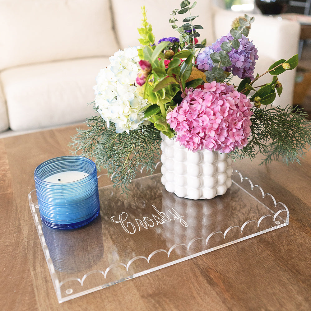 monogrammed clear scalloped acrylic tray with candle and flowers