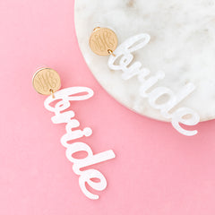 bride earrings on pink