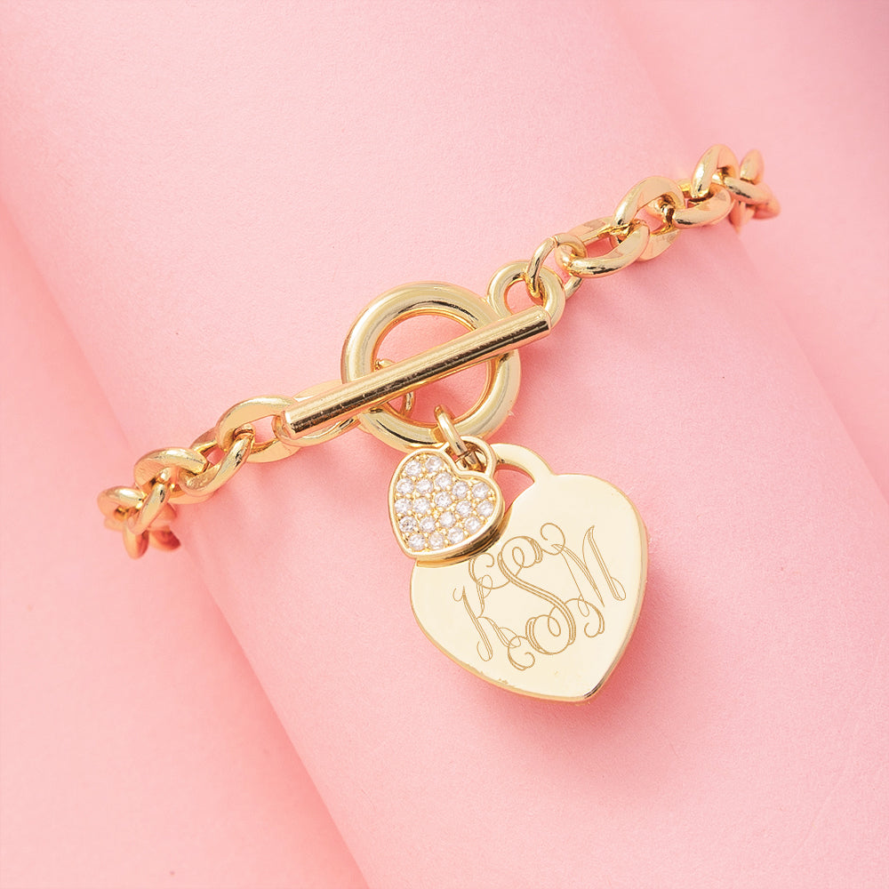 monogrammed heart bracelet in gold on pink