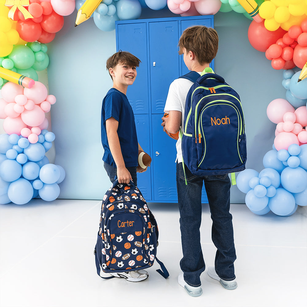 Sports balls and navy backpacks on two boys 