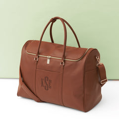 brown weekend travel bag on green background