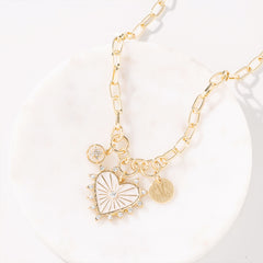 Charm heart necklace on marble dish