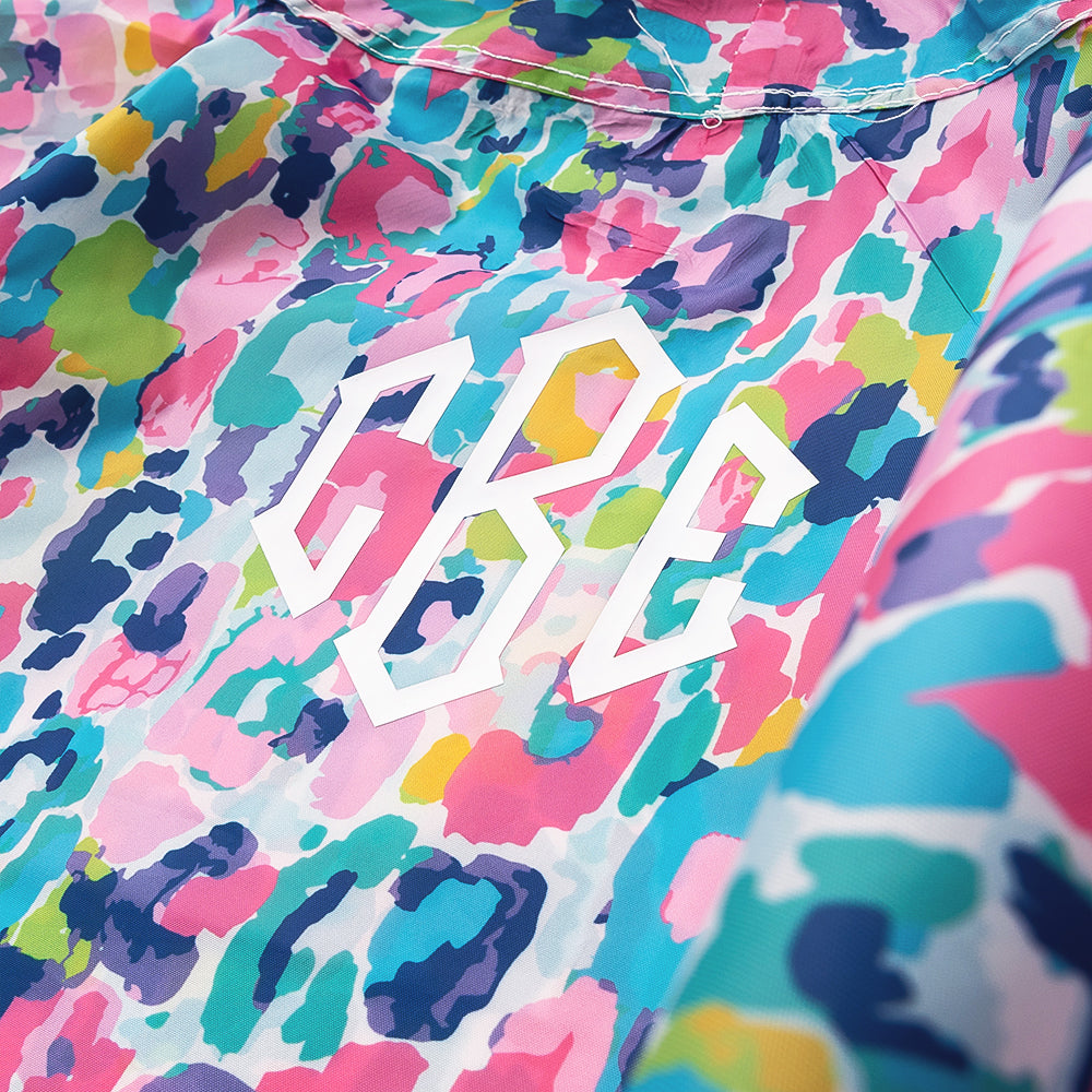 close up of monogrammed watercolor cheetah rain poncho