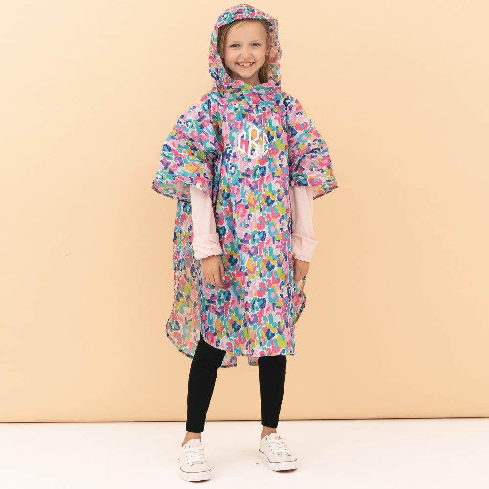 girl wearing monogrammed watercolor cheetah rain poncho with hood