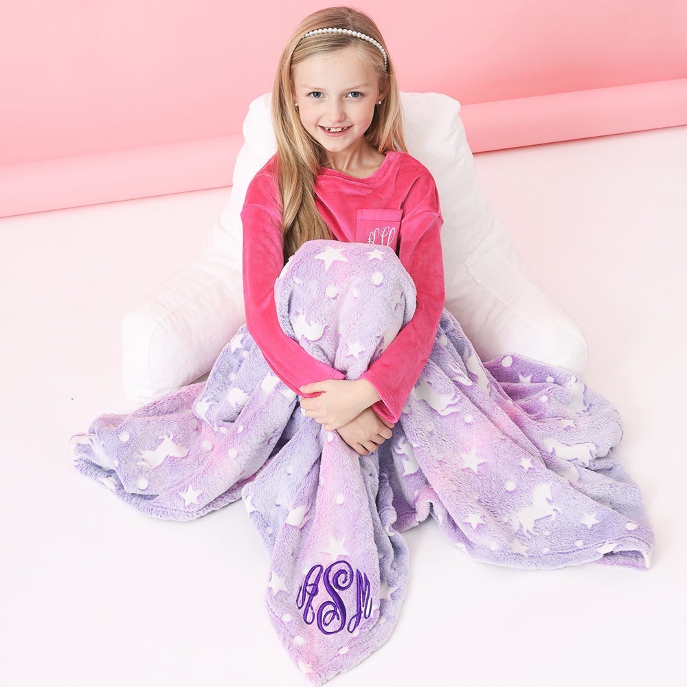 unicorn pink and purple monogrammed blanket over girl