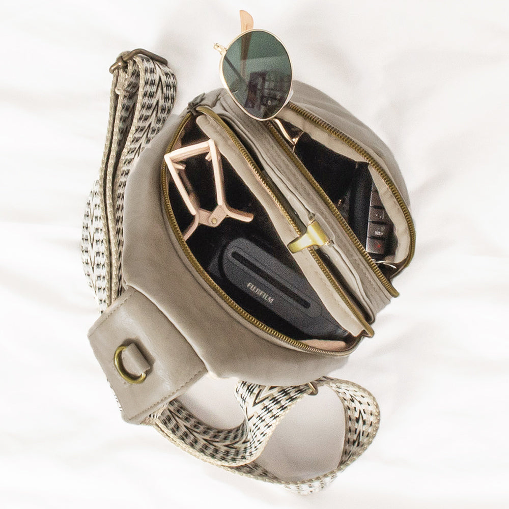 inside of taupe sling purse