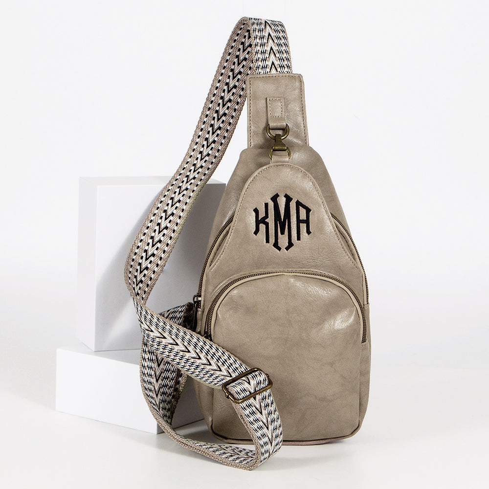 studio shot of taupe sling purse