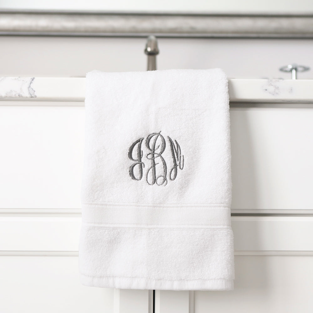 white hand towel hanging off the sink