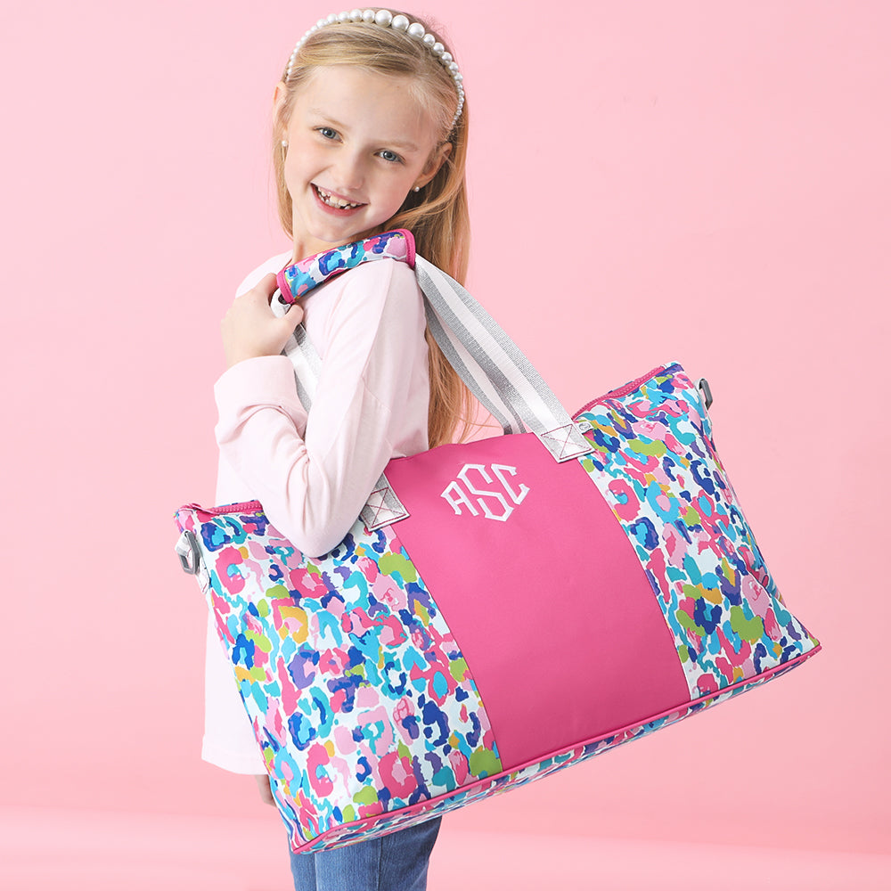 girl with weekend bag in watercolor cheetah over shoulder