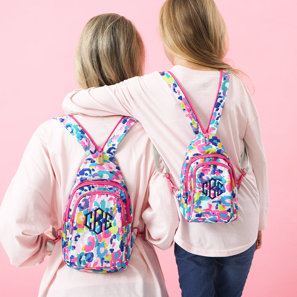 water color cheetah mom and me sling backpacks on backs