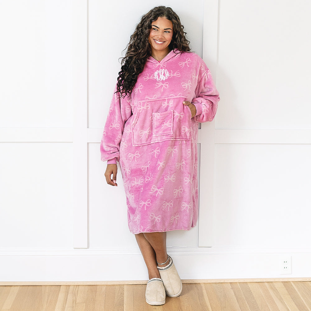 girl wearing monogrammed extra large blanket hoodie in pink bows