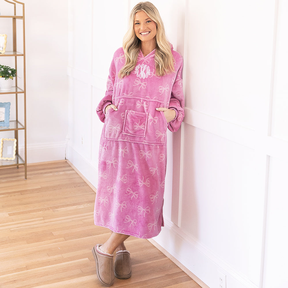 girl wearing monogrammed pink bows xl blanket hoodie with moccasins