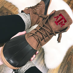 brown texas a&m duck boots with socks in hand