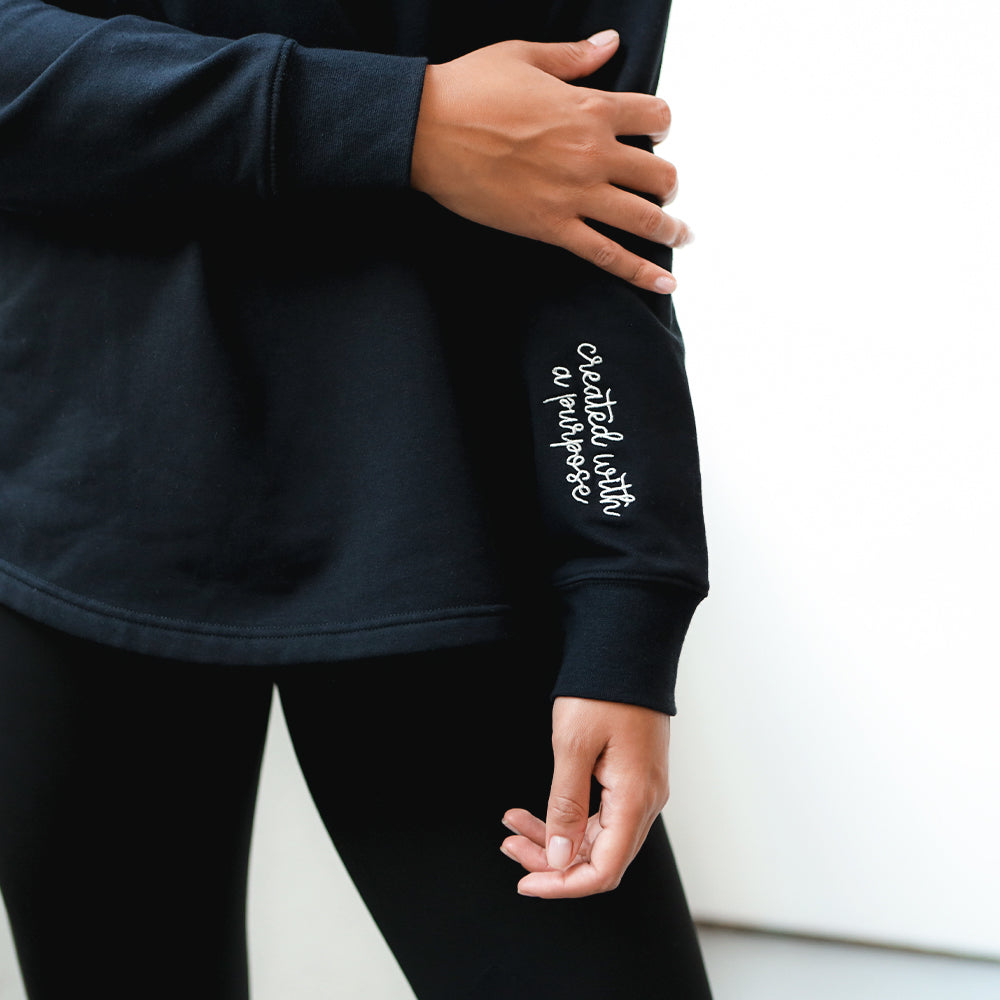 up close of black faith pullover