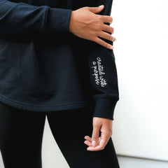 up close of black faith pullover