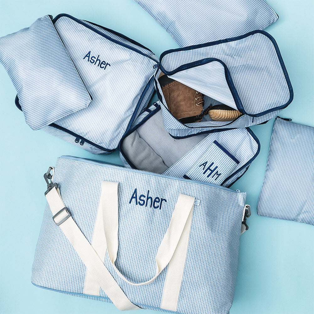 personalized kids weekend bag in navy seersucker with matching packing bag set