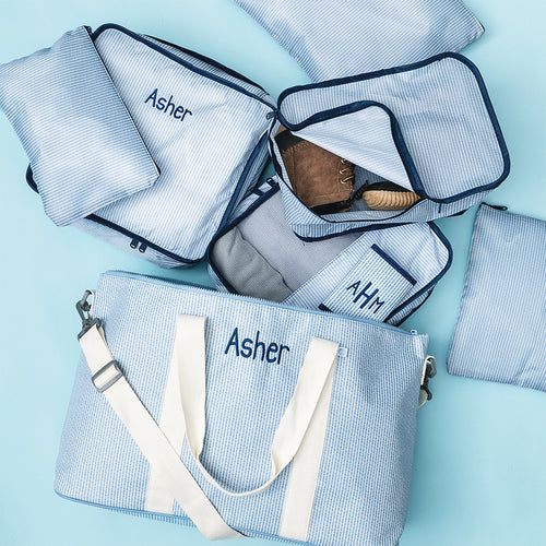 personalized kids weekend bag in navy seersucker with matching packing bag set