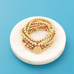 Colorful bracelet stack on blue