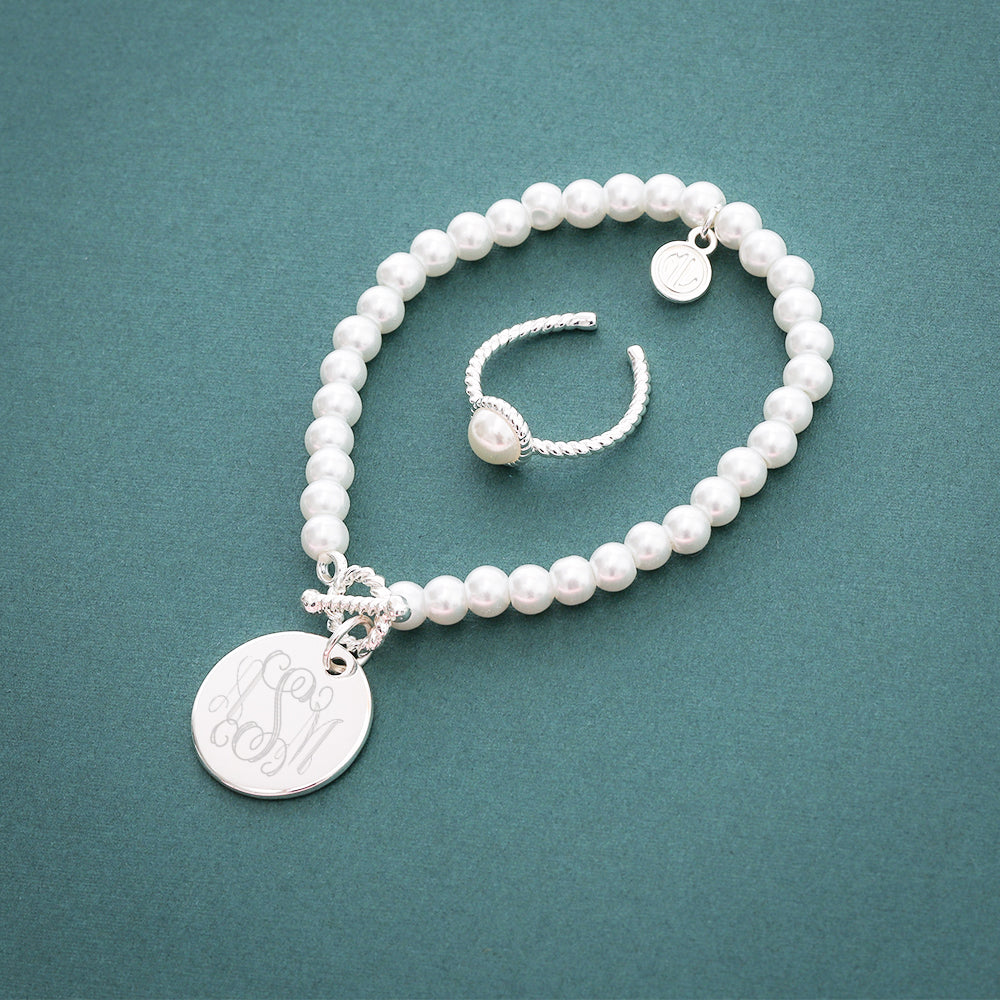 Ring paired with pearl bracelet green background FL